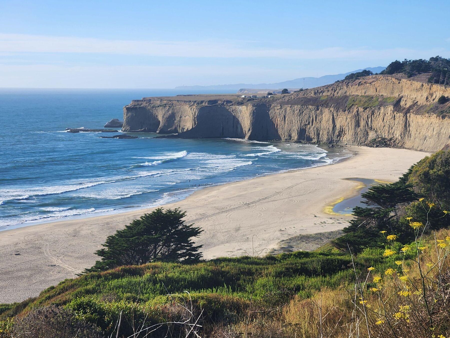 Surf breaking below the bluffs on the San Mateo Coastside